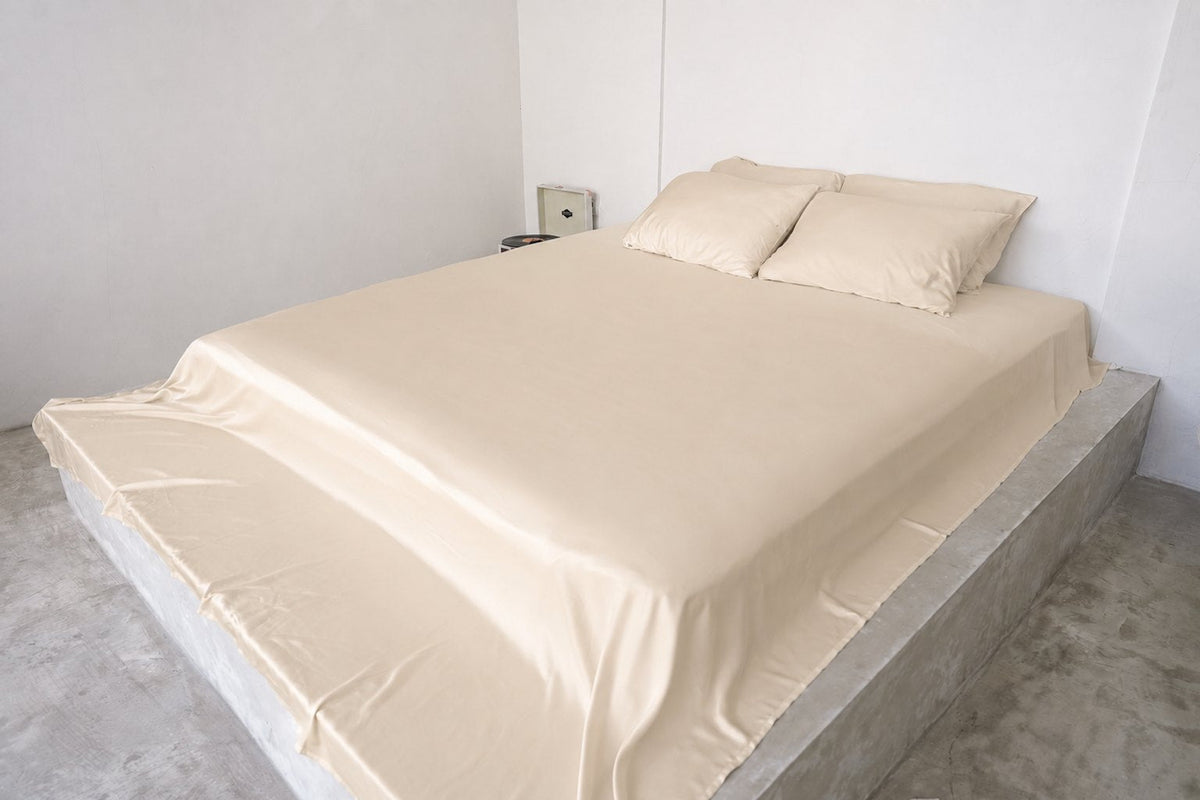 Champagne Silk bamboo sheet set on a queen bed