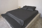 Charcoal Whisper bamboo sheet set on a queen bed